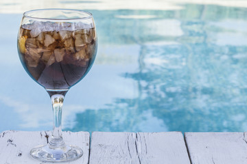 Cola refeshment next to swimming pool