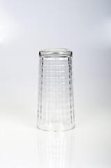 An inverted drinking glass on a white background.