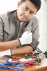 repair man, engineer fixing computer part on work table