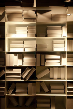 books, white pale book shelf wallpaper in shadow warm lighting