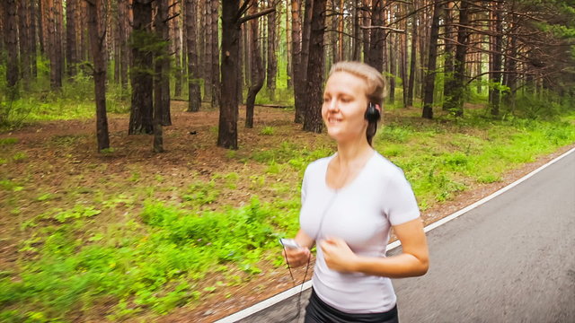 Jogging in park, young woman running in the park