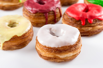 Several colorful fondant croissant and donut mixture