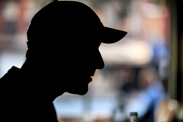 Fototapeta premium Male in baseball cap, silhouette