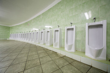 Row of urinals in a public toilet