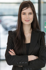 Fototapeta premium Smiling business woman on a background of a window close up
