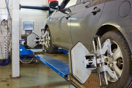 Car on stand for precision wheel alignment