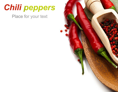 chili peppers and peppercorns in wooden csoop