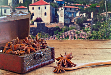 Star anise spice on rustic wooden table with old countryside vil