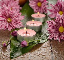 Burning candle and flowers