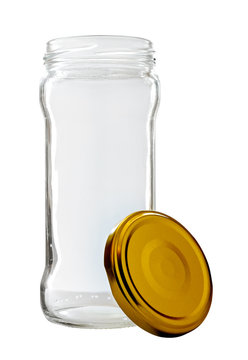 High transparent glass jar on white background, with the open gold color top