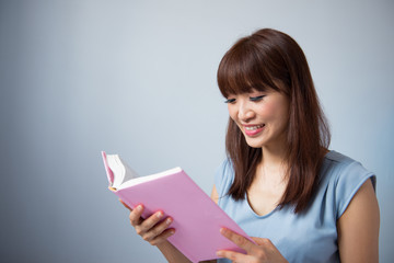 Asian woman reading a book