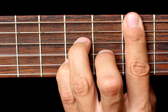 hand holding a chord, and vibrating strings