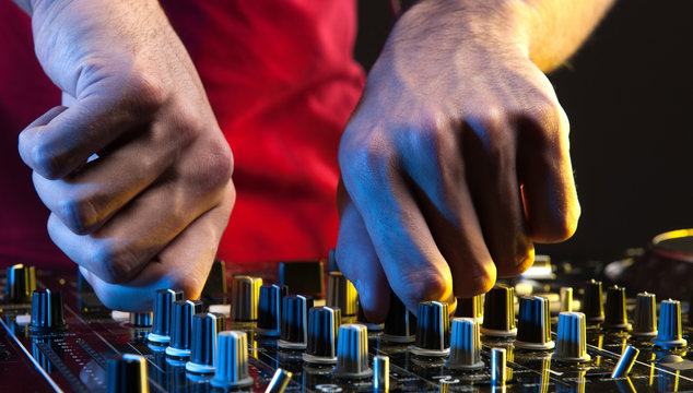 DJ at work. Close-up of DJ hands making music