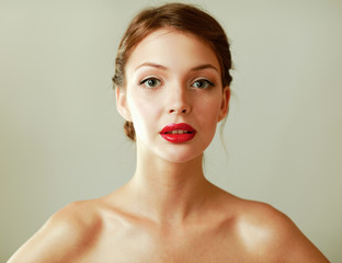 A beautiful woman, portrait isolated on grey background