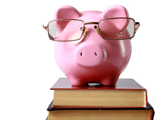 piggy bank with glasses and bookin isolated white background