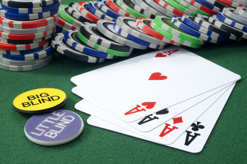 Four aces and chips on a green felt
