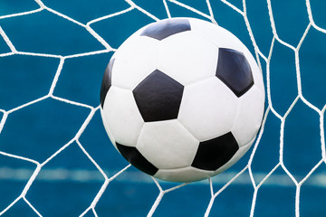 Fototapeta na wymiar soccer ball in goal net
