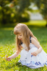 Fototapeta na wymiar Girl with sunflower in summer field