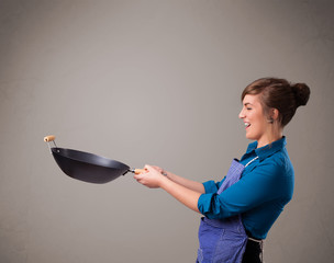 Young lady holding a frying pan