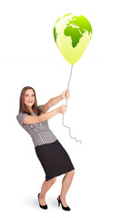 Happy lady holding a green globe balloon