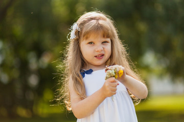 Girl with sunflower in summer field