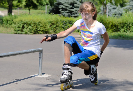Teenage girl balancing on her rollerblades