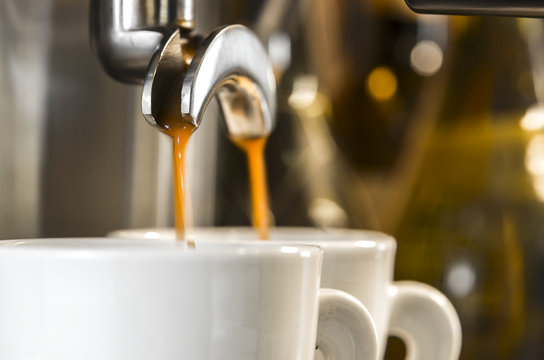 golden espresso flowing into cups