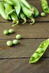green peas on wooden surface