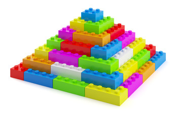 Plastic toy blocks pyramid on white background