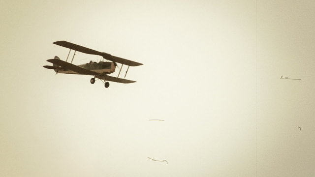 Flying vintage combat biplane in air