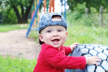 portrait of happy baby age of 10 months outdoors