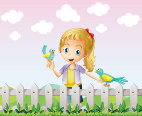 A girl with two birds near the wooden fence