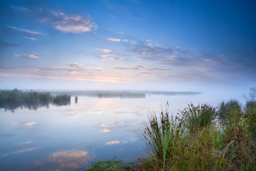 Naklejka na ściany i meble calm misty morning over lake