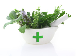Porcelain mortar with pharmacy cross and fresh herbs