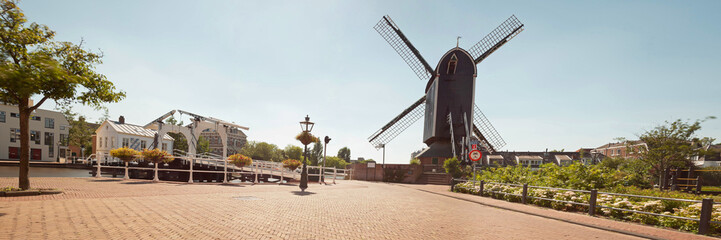 Panoramic photo of dutch city Leiden in summer. Windmill and old
