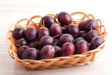 Fresh plums in basket