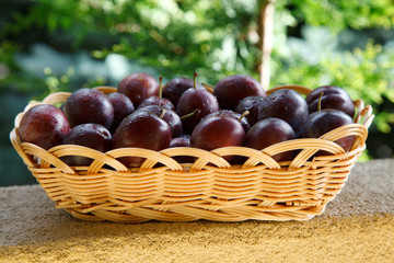 Fresh plums in basket