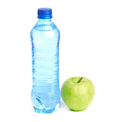 Bottle of sparkling water and green apple