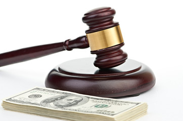 Obraz na płótnie Canvas Law gavel on a stack of American money.