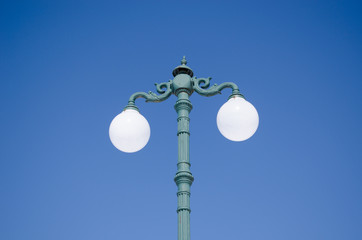 Fototapeta na wymiar vintage light pole double twin glass lamp blue sky