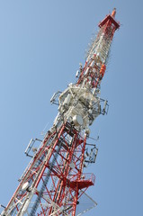 Tower with broadcast antenna system against blue sky