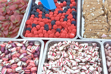 Assortment of various jelly candies with plastic spatula