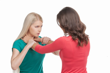 Women fight. Two women fighting while isolated on white