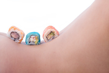 Young beautiful woman with Japanese sushi rolls, on white