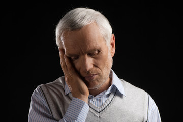 Toothache. Portrait of white hair senior man holding his hand on