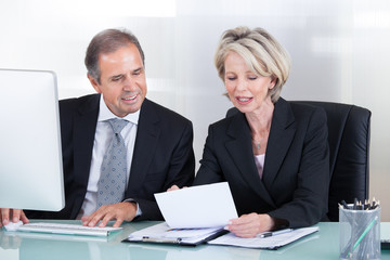 Fototapeta premium Mature Businessman And Businesswoman At Work