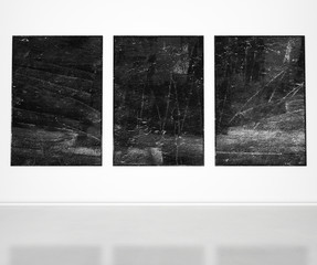 three black posters on white wall