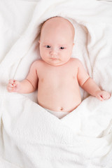 Cute baby wrapped into towels