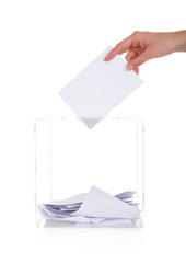 Closeup Of Hand Inserting Ballot In Box
