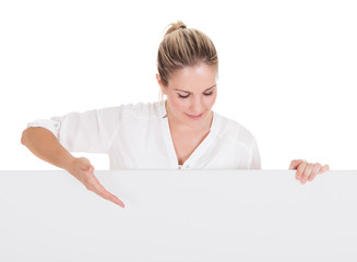 Young woman presenting blank placard